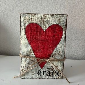Newspaper and stamped heart on block